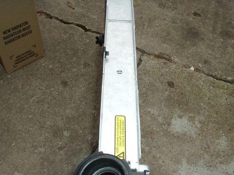 1993 Ford Taurus - New radiator in its original packaging, showing multilingual labeling and manufacturing origin.