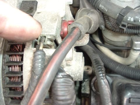 1993 Ford Taurus - Close-up view of electrical connections on an automotive alternator.