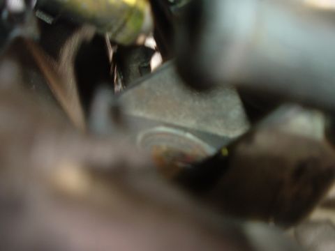 1993 Ford Taurus - A close-up view of a vehicle's engine component, showing wear and tear.