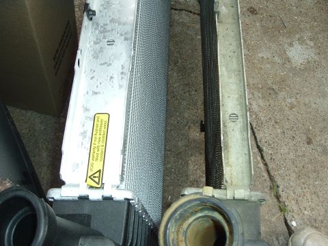1993 Ford Taurus - Radiator part with a warning sticker about fluid and warranty. Supermotors.net logo is present.