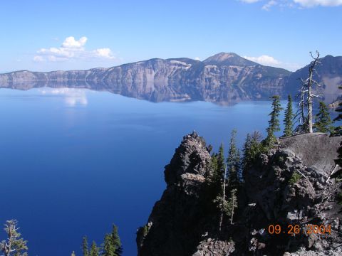 1994 Ford Bronco - A scenic view of Crater Lake on September 26, 2004, shows mountains reflected in the calm blue water.