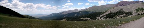 1986 Ford Bronco - A panoramic view of a vast mountain range under a partly cloudy sky.