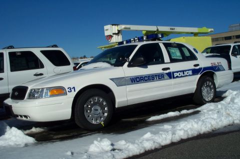 2001 Ford Crown Victoria - Worcester Police car, unit 31, parked in the snow with another vehicle behind it.