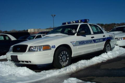 2001 Ford Crown Victoria - A white 2001 Ford Crown Victoria police car, marked 'Worcester Police', sits parked in the snow.