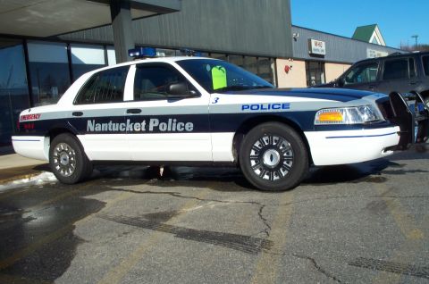 2001 Ford Crown Victoria - A 2001 Ford Crown Victoria police car is parked outside a building, showing "Nantucket Police" on its side.