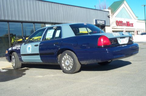 2001 Ford Crown Victoria - Massachusetts State Police Crown Victoria, unit 212, seen parked in front of a commercial building.