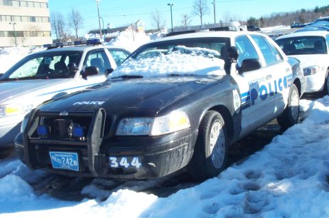 2001 Ford Crown Victoria - Two police cars are parked in the snow, one with a push bar and the number 344 on the front.