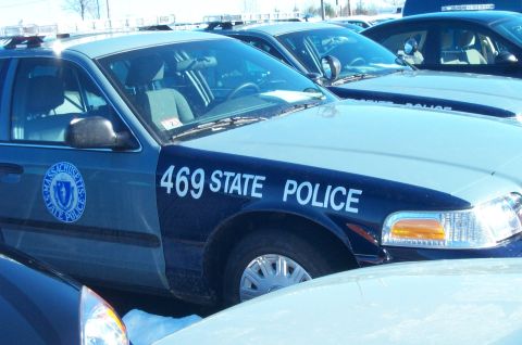2001 Ford Crown Victoria - A Massachusetts State Police vehicle is parked in a lot, with other cars visible in the background.