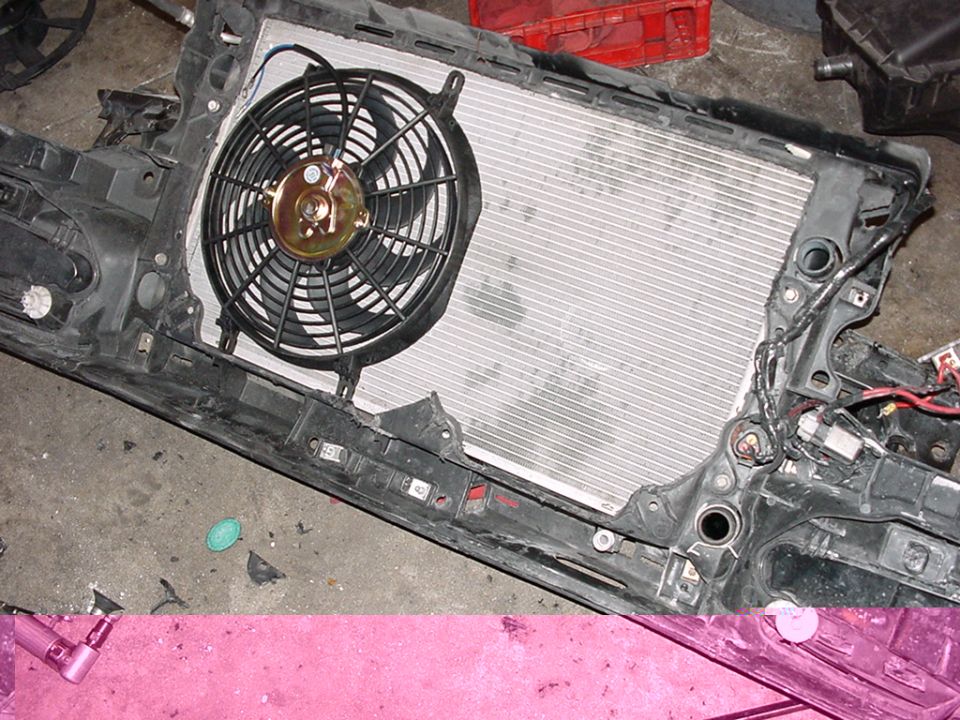 Radiator and fan assembly with black plastic housing and metal fins