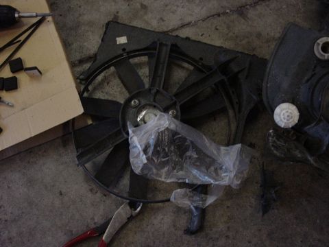 1998 Volkswagen Jetta - Radiator fan assembly and tools on a concrete floor.