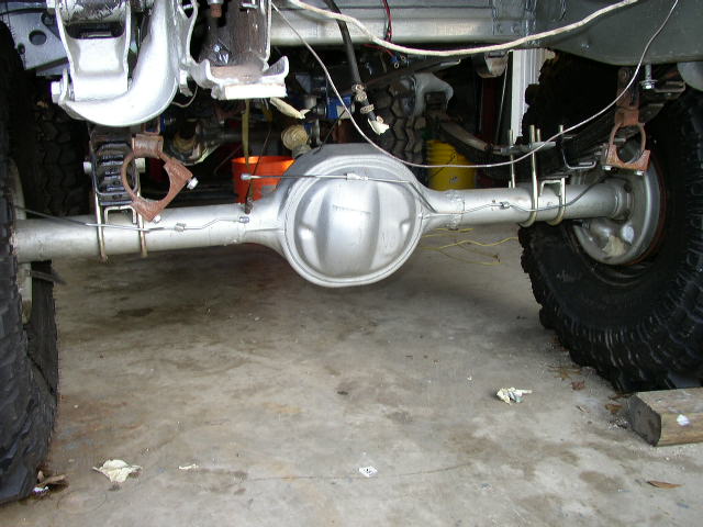 Rear axle assembly with leaf springs and shocks visible