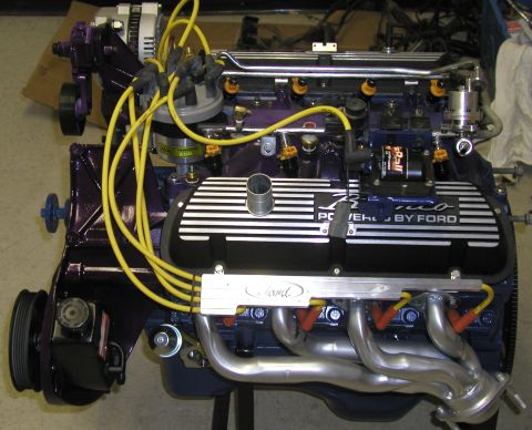 1988 Ford Bronco - Close-up of a Ford engine, showing "POWERED BY FORD" valve covers and yellow spark plug wires.