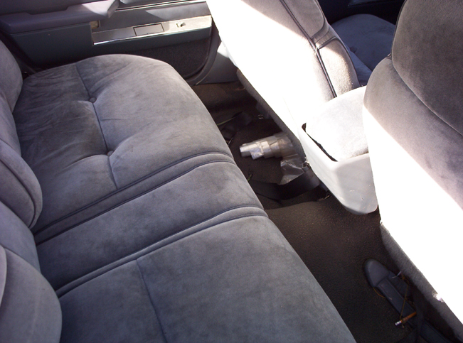 Gray velour rear seats and door panel of a 1991 Ford Crown Victoria LTD