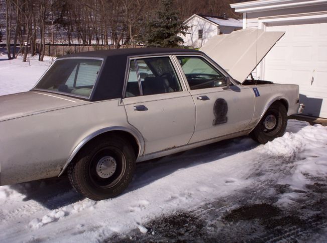 1979 Dodge St. Regis police car with hood open, parked in snow