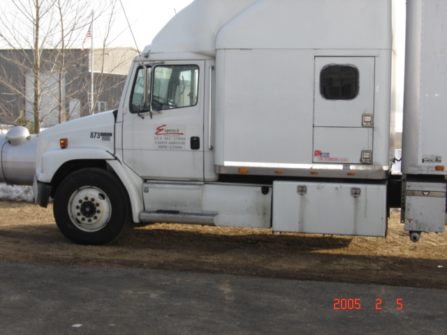 Side view of a white semi-truck cab with "Express-1" logo on the door