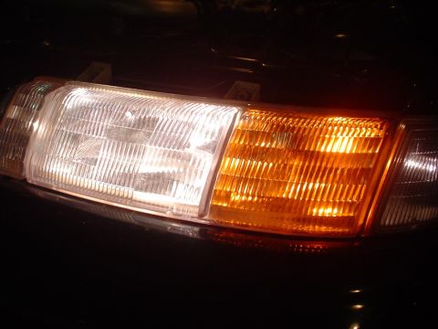 1993 Ford Taurus - Close-up of a vehicle's front lighting assembly, showing the headlight and turn signal.