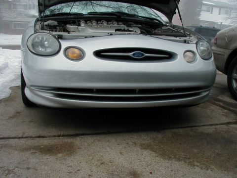 1997 Ford Taurus - Front view of a silver 1997 Ford Taurus with the hood open, parked outside.