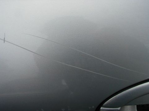 1997 Ford Taurus - This image shows several long scratches on the exterior of a vehicle.