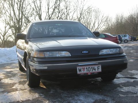 1992 Ford Crown Victoria - A black 1992 Ford Crown Victoria is parked outside on a cold day with snow on the ground.