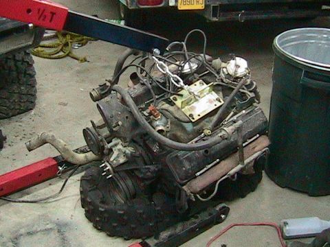 1981 Chevrolet C/K Pickup - Engine assembly is suspended by an engine hoist, ready for installation or removal.