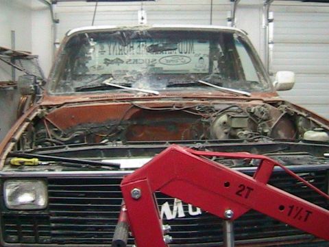 1981 Chevrolet C/K Pickup - This truck appears to be undergoing some form of repair or restoration, with its engine bay completely empty.
