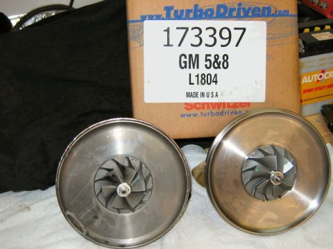 1985 Ford LTD Crown Victoria - Two turbochargers are shown with a box that has part numbers and manufacturer information.