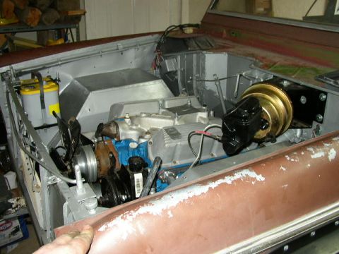 1995 Ford Bronco - The engine bay of a Ford Bronco is shown with a new brake booster and battery installed.