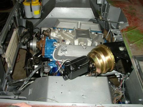 1995 Ford Bronco - Engine bay components including a blue engine, silver intake, and brake booster are visible.