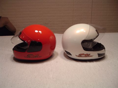 1995 Mercury Grand Marquis - Two motorcycle helmets, one red and one white, are displayed side-by-side.