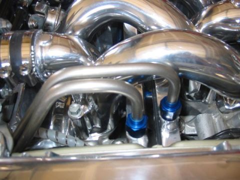 1993 Ford Taurus - Close-up view of a custom chrome engine intake manifold with visible tubing and fittings.