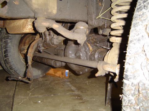 1979 Ford Bronco - Close-up view of the undercarriage of a vehicle, highlighting suspension components and the differential.