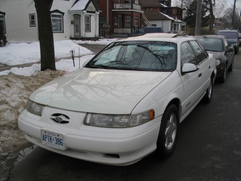 1993 Ford Taurus - This 1993 Ford Taurus sedan is seen parked on a street with snow on the ground, indicating a winter setting.