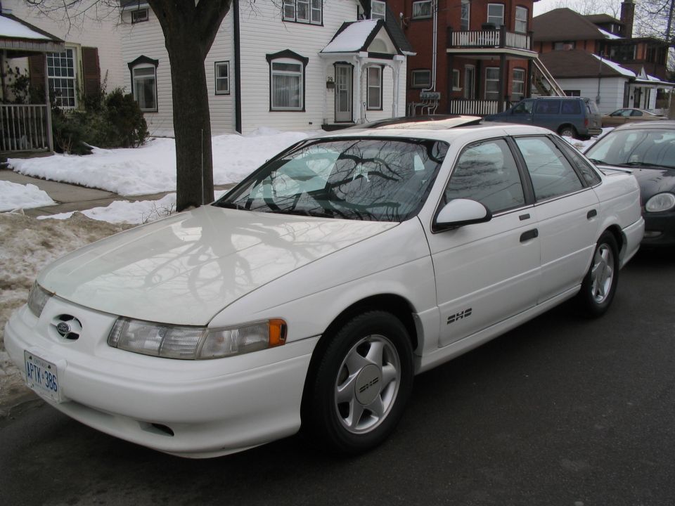 White 1993 Ford Taurus parked on a snowy street