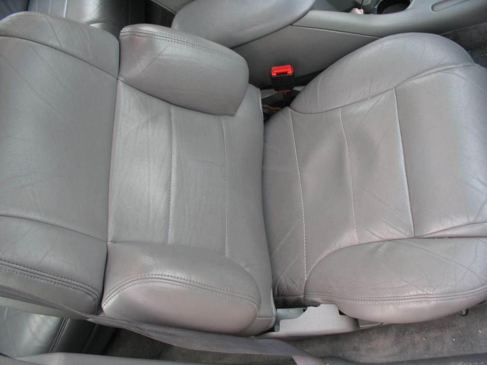 Gray leather interior seats with a red seatbelt buckle visible