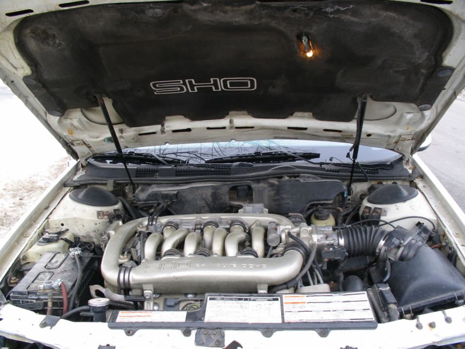 1993 Ford Taurus SHO engine bay with V6 engine and SHO badging on hood liner