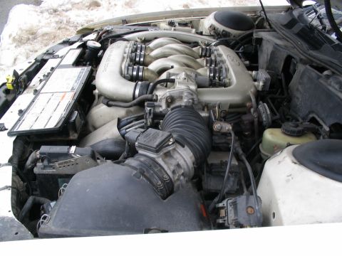 1993 Ford Taurus - Close-up view of a car's engine bay, showing the intake manifold and other engine components.