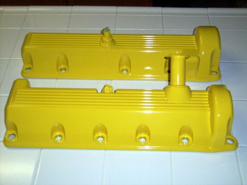 2002 Ford Mustang - Pair of yellow valve covers, likely for an engine build or restoration project.