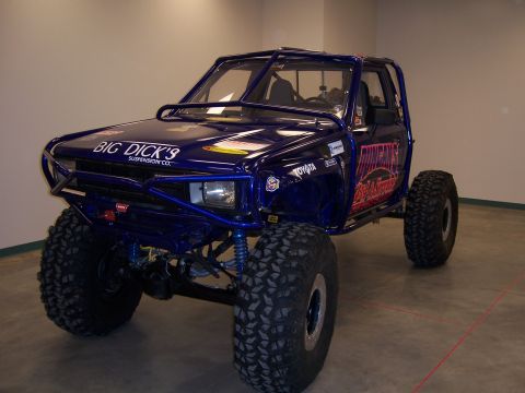1999 Jeep TJ - This heavily modified Toyota pickup features a custom roll cage and oversized tires for off-road use.