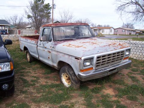 1979 Ford F-100 - This weathered 1979 Ford F-100 pickup truck shows significant rust and wear.