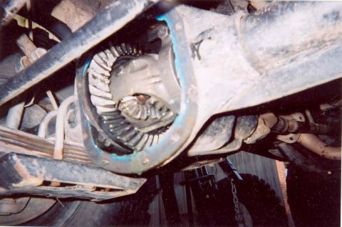 1984 Jeep Wrangler - Underside view of a vehicle's rear axle, focusing on the differential and suspension components.