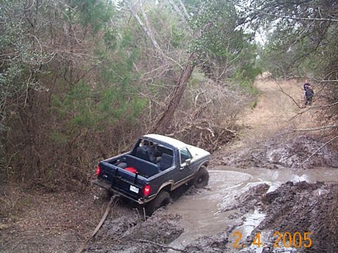 1986 Ford Bronco - This 1987 Ford Bronco is deep in the mud on a wooded trail.