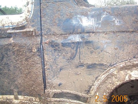 1986 Ford Bronco - Vehicle heavily covered in mud after off-road use.