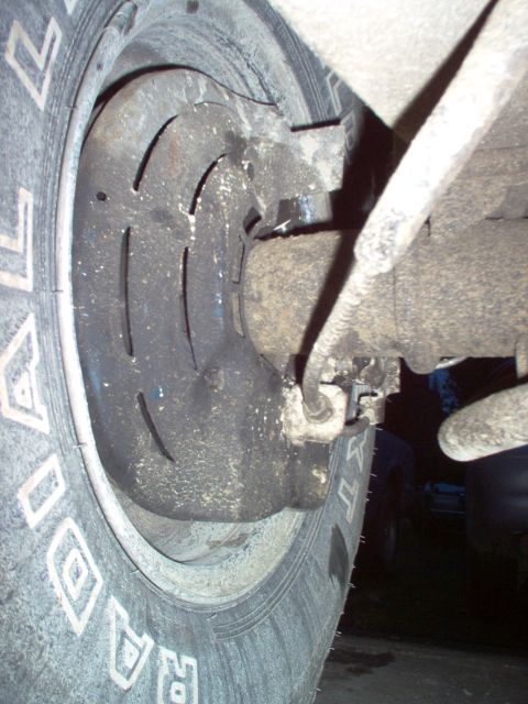 1979 Ford Bronco - Close-up view of a rear disc brake assembly, showing the rotor and caliper components.