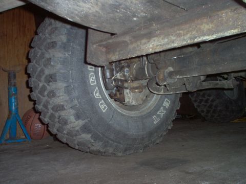 1979 Ford Bronco - Close-up view of a vehicle's rear wheel and suspension, highlighting a disc brake conversion kit.