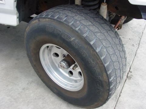 1996 Ford Bronco - Close-up of a BFGoodrich All-Terrain T/A tire mounted on a silver wheel.