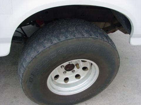 1996 Ford Bronco - Close-up of a tire and wheel assembly on a white vehicle.