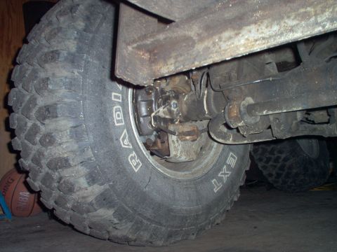 1979 Ford Bronco - Close-up view of a vehicle's rear axle, showing the brake assembly and a large tire.