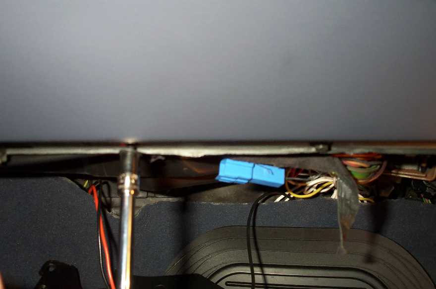 To gain more access, I removed the glove box by removing it's three screws. Pictures here, is a socket with an extension, removing the black screws.