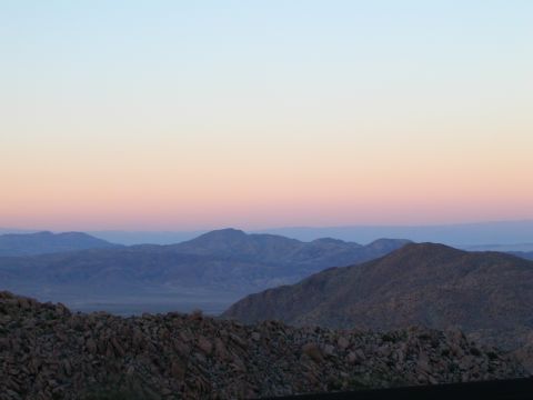 1993 Ford Bronco - A mountain vista unfolds under a pastel sunset sky, with a rocky foreground.