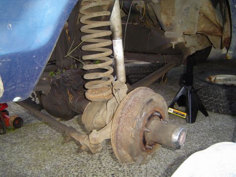 1979 Ford Bronco - The rear suspension and axle assembly of a vehicle are shown, appearing to be undergoing maintenance or repair.